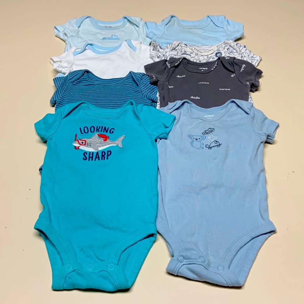 Assorted brands of baby onesies